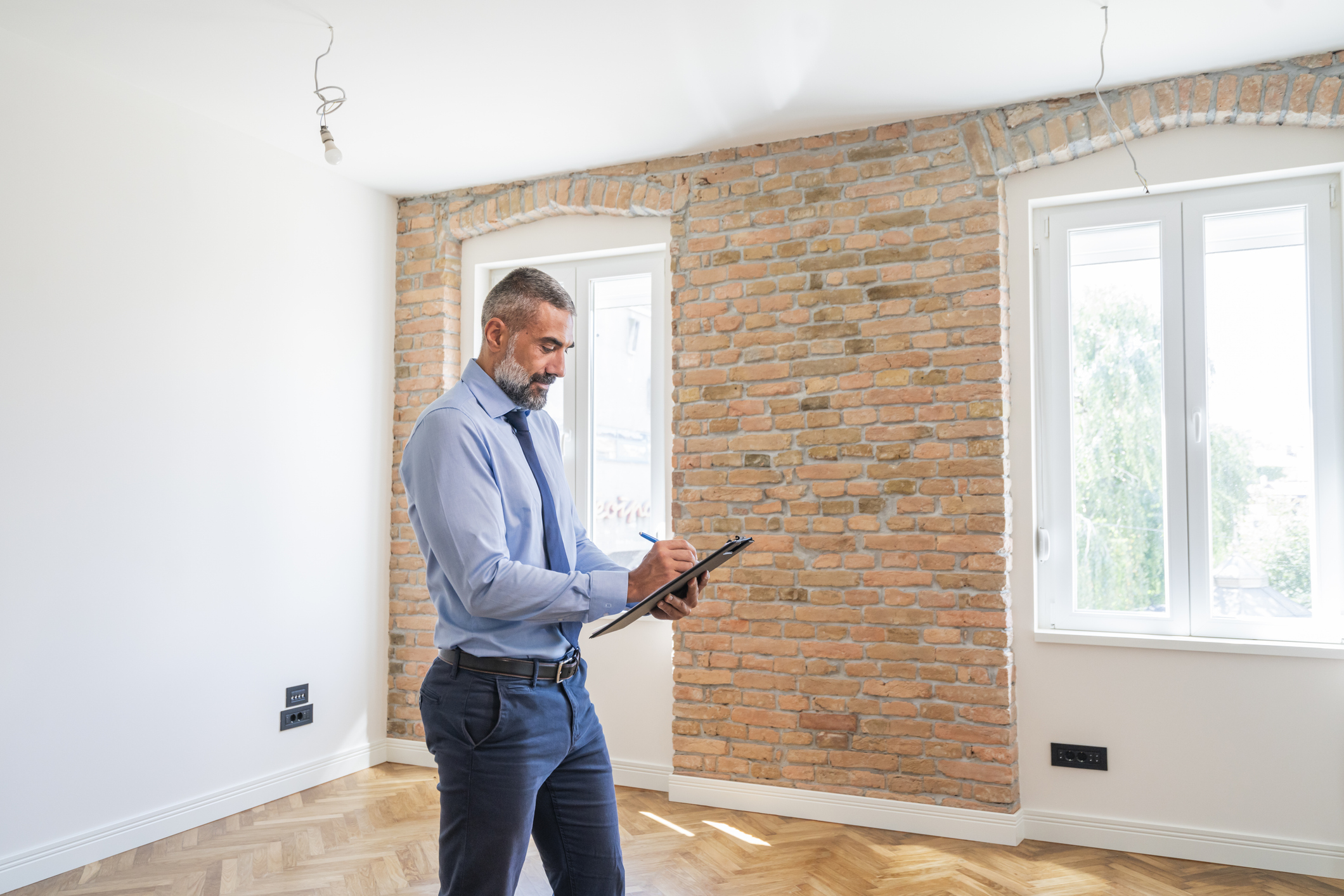 Mature man as a real estate agent Mature man as a real estate agent holding clipboard