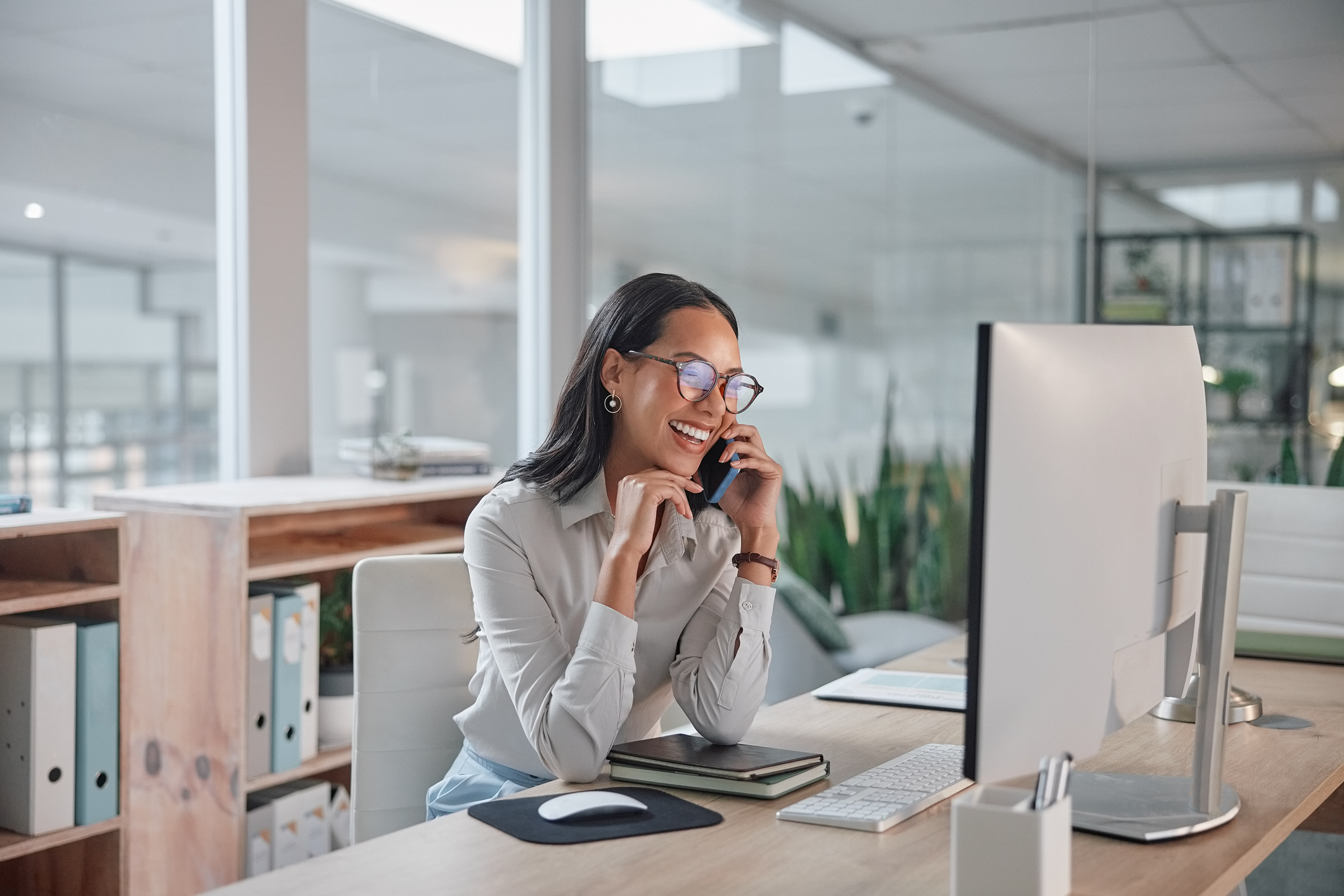 Phone call, business and woman with a computer, conversation and smile with project and talking. Person, office and employee with pc and worker with joy and laughing with communication and discussion Phone call, business and woman with a computer, conversation and smile with project and talking. Person, office and employee with pc and worker with joy and laughing with communication and discussion